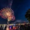 family watching Fourth of July fireworks picnic park summer dog blanket